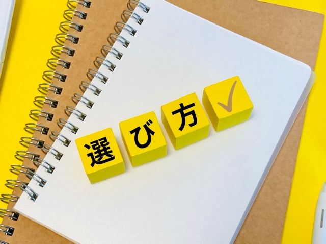 ノートとペン、黄色い「選び方」のカードの写真